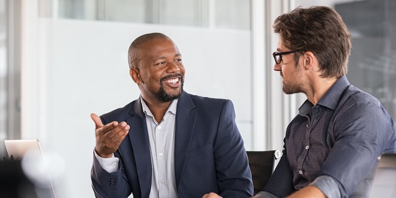 Interested Man Listening to His Hard Money Lender Representative Answer a Question