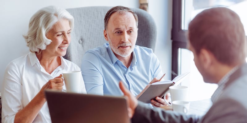 Couple discussing their financial advisor investment strategy with a financial advisor