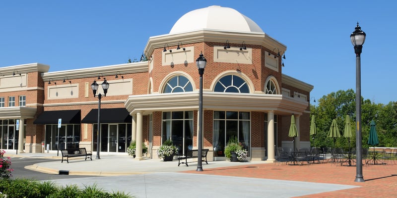 Photo of a high-end red brick strip mall. Are strip malls a good investment?